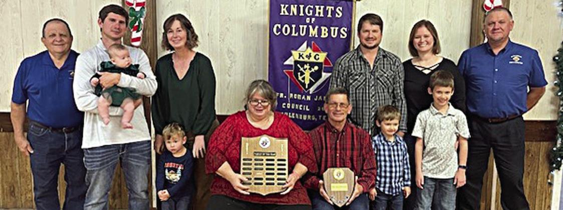 SCHULENBURG KC Family of the Year for 2025 was awarded to the Shimek family – Mark and Cynthia Shimek shown with their sons and families along with KC Council 2902 representatives – (from left) KC financial secretary Rodney Kalich; Richard Shimek holding baby Maeve, Ashley Shimek with Roman standing in front of her, Cynthia and Mark Shimek holding plaques, Raymond Shimek with Asher standing in front of him, and Jamie Shimek with Luke standing in front of her; and KC grand knight Paul Zapalac.