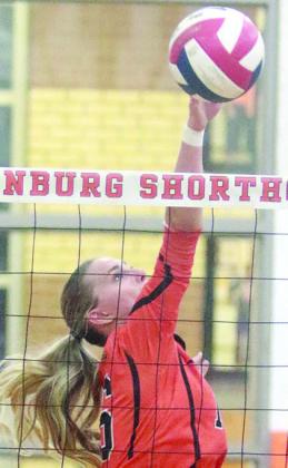 Jenna Guentert tips the ball over for a kill in the fourth set last Tuesday. Sticker Photo By Darrell Vyvjala