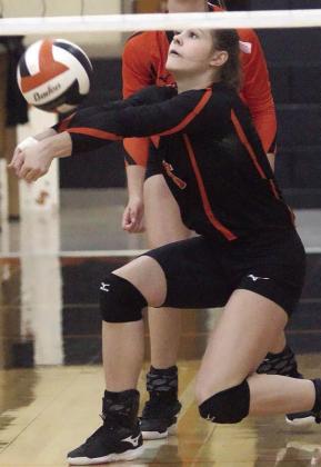 Haylee Vacek saves a ball near the net in the first set against Ganado. Sticker Photo By Darrell Vyvjala