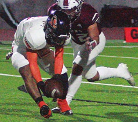 Keisean Johnson picks up a blocked extra-point kick that he turned into two points with an 85-yard return in the first quarter. Sticker Photo By Layne Vyvjala