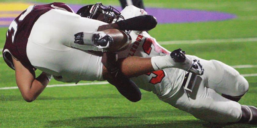 Rodney Walton takes down Owen Espinoza after a short gain early in the third quarter. Sticker Photo By Layne Vyvjala