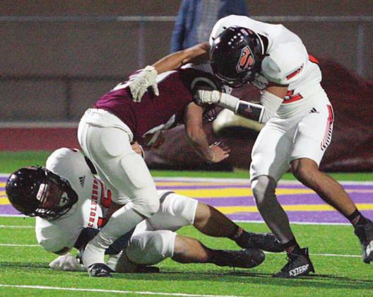 Bryce Stoever (on ground) and Jorge Olvera (right) combine to drop Daniel Pena on kickoff coverage to start the third quarter. Their tackle after a deep boot by Brycen Schramek pinned Kenedy at its own 9. Sticker Photo By Layne Vyvjala