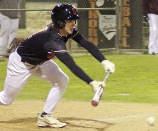 Nick Goode drops down a sacrifice bunt in the bottom of the fifth inning last Tuesday. Sticker Photo By Darrell Vyvjala