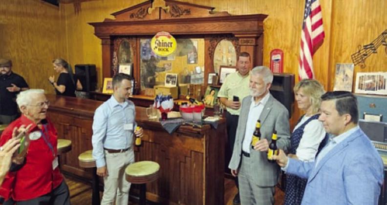 Ice cold Shiner beer, brewed in the nearby town of Shiner, was served at the Polka Lovers Club of Texas Museum. Shown are (foreground from left) Willie Bohuslav, PLCTM immediate past president; a Czech presidential representative; Mark Hermes, Texas Czech Heritage &amp;amp; Cultural Center manager; President Petr Pavel and his wife Eva Pavlová; and Miloslav Stašek, Czech Ambassador to the United States located in Houston. Behind them to the left is the museum’s newest exhibit, Frank’s Bar.