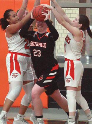 Airyanna Rodriguez (left) and Morgan Marburger (right) pressure a Smithville player into a turnover. Sticker Photo By Darrell Vyvjala