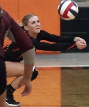 Mallory Bonner makes a lunging dig in the second set against East Bernard. Sticker Photo By Darrell Vyvjala