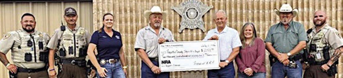 Fayette County Sheriff 's Off ice personnel shown receiving a $2,772.90 grant check from The NRA Foundation and Friends of NRA are (from left) Deputy Herman Olvera, Sgt. Ron Naumann, Sgt. Angela Lala, Sheriff Keith Korenek, Dennis Brower-Friends of NRA, Renee Moreland-FCSO, Lt. David Beyer and Deputy Joe Gonzales.