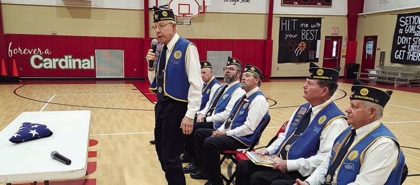 MIDDLE PHOTO – Attending the flag-folding program were (from left) Barbara Brown, Legion Auxiliary member; and Jim Brown, Rick Todd, Gerald Smith, Ken J. Berger, Vernon Dittrich and Jack Niesner, all Legion members. BOTTOM PHOTO – Describing the meaning of each fold of the flag as it is being folded is Legion member Ken. J. Berger (standing).