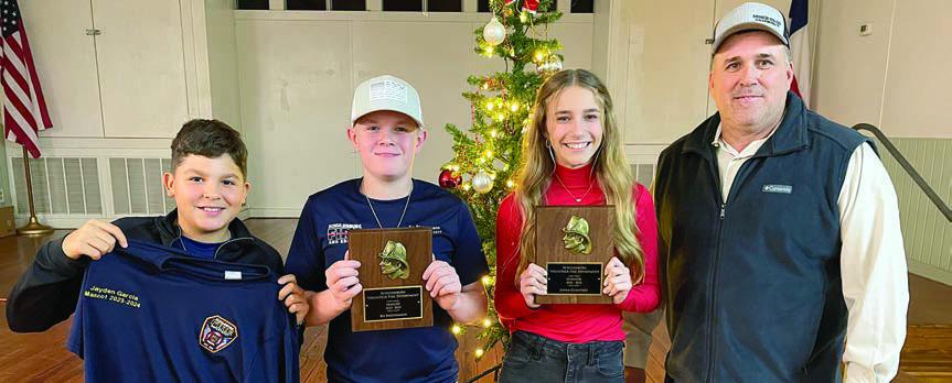 MASCOTS &amp; SPONSORS – Chief Darren Guentert (right) recognized 2024 mascot Jayden Garcia (left), 2023 mascot Bo Brossmann (second from left), 2023 sponsor Jenna Guentert (second from right), and (not shown) 2024 sponsor Kaysen Wick. Sticker Photo By Darrell Vyvjala