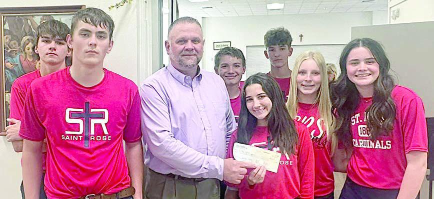 Knights of Columbus Council 2902 held a fish fry on Ash Wednesday, Feb. 18 and donated the proceeds to St. Rose of Lima Catholic School. Shown at the check presentation are (front row, from left) Kaleb Zapalac; Paul Zapalac, grand knight, representing Council 2902; Elli Wotipka, Brynn Bubela, Charlotte Schmidt, (back row) Bryson Ohnheiser, Patrick Taylor and Austin Reeves.