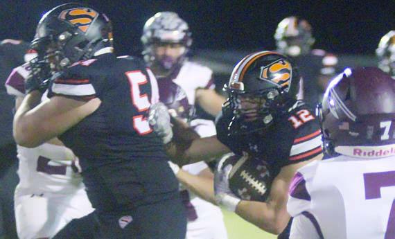 Tyson Wagner (left) leads the way for Reid Janda (No. 12) on a successful screen pass in the fourth quarter. Sticker Photo By Darrell Vyvjala