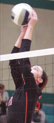 Meredith Magliolo goes high to tap down an over-pass in the second set. Sticker Photo By Layne Vyvjala