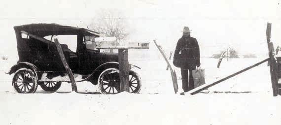A mail carrier, possibly John Giese, is shown holding a mail bag and pouch after the Jan. 23, 1926, snowfall.