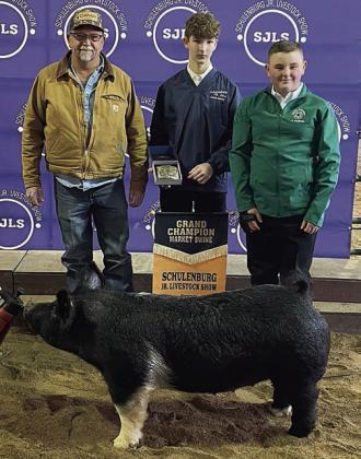 SWINE – Exhibitor: Abraham McBride (right). Sale price: $11,500. Sticker Photo By Darrell Vyvjala