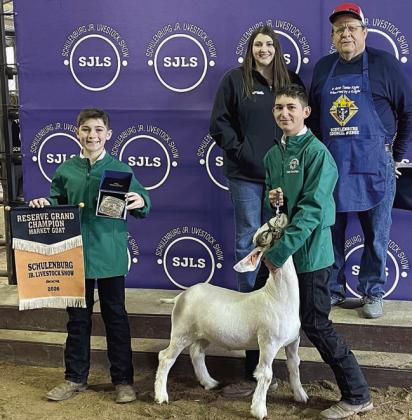 RESERVE CHAMPION MARKET GOAT – Exhibitor: Dylan Zweschper (front, right). Sale price: $4,000. Sticker Photo By Darrell Vyvjala