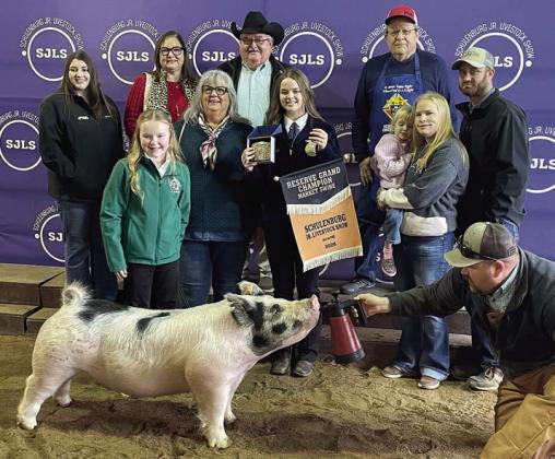 RESERVE CHAMPION MARKET SWINE – Exhibitor: Abigale McBride (front, left). Sale price: $10,350. Sticker Photo By Darrell Vyvjala
