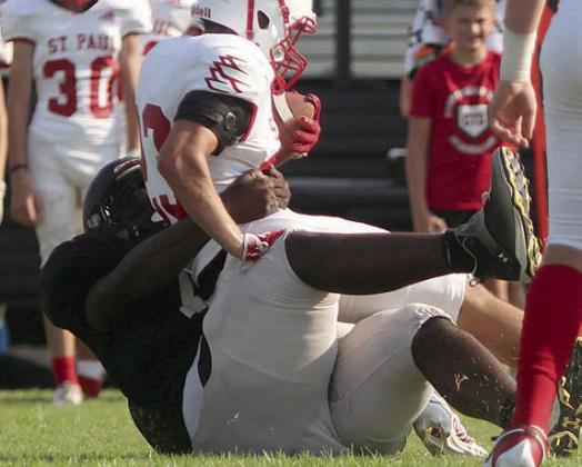Ricky Walton drags down a Cardinal for a 1-yard loss. Sticker Photo By Darrell Vyvjala