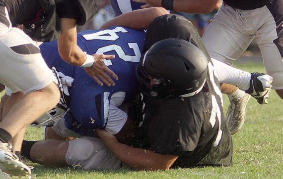 Marshall Wellborn stops a Bulldog for no gain on the first snap of the timed portion of the scrimmage. Sticker Photo By Darrell Vyvjala