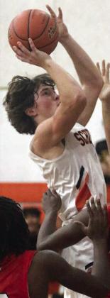 Jayse Janda goes up in traffic for a bucket in the second half against El Campo. Sticker Photo By Darrell Vyvjala