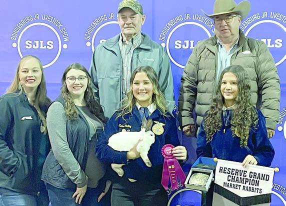 RESERVE CHAMPION MARKET RABBITS – Exhibitor: Claire Oeding (front, second from right). Sales price: $4,050. Sticker Photo By Darrell Vyvjala