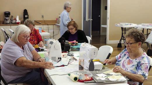 Working on the charity project that is providing quilts for Hill Country flood victims are (seated at table, from left) Linda Polk, Debbie Huebel, Gay Dobbs, Kathy Bertsch and (back) Kay Marburger.