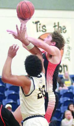Jayse Janda makes a driving shot in the first quarter despite getting fouled. Sticker Photo By Darrell Vyvjala
