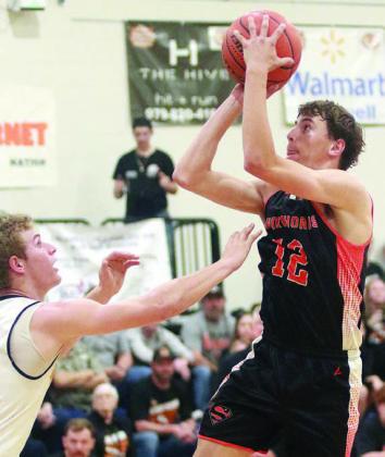 Van Prihoda scores in the lane on an inbound play in the third quarter. Sticker Photo By Darrell Vyvjala