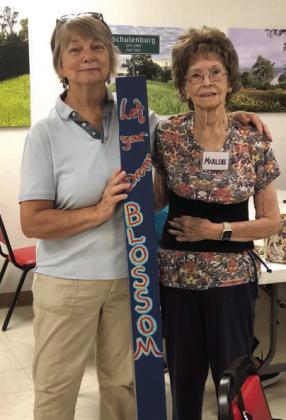 Artist instructor Claire Lewis (left) with a garden pole she painted and Marlene Renison (right), who purchased it the day it was delivered!