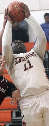 Tavondrick Ellison scores under the basket in the first quarter against Ganado. Sticker Photo By Darrell Vyvjala