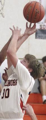 LJ Schindler goes up for an offensive rebound in the fourth quarter last Tuesday. Sticker Photo By Darrell Vyvjala