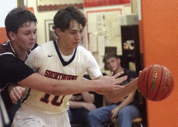 Adam Schramek steps in front of an Indian for a steal in the second quarter. Sticker Photo By Darrell Vyvjala