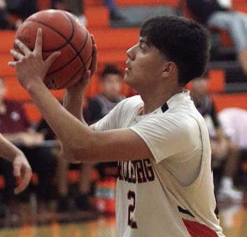 Victor Mandujano sets himself before releasing one of his two three-point field goals on Jan. 6. Sticker Photo By Darrell Vyvjala