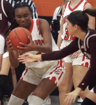 Jashiya Jackson gets a steal in first half of the Lady Horns’ district opener. Sticker Photo By Darrell Vyvjala