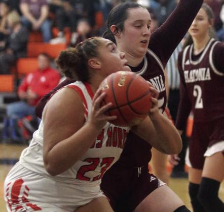 Arianna Vincent draws a foul on a second-half drive last Tuesday. Sticker Photo By Darrell Vyvjala