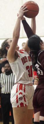 Grace Schramek fights for a rebound in the second half against Flatonia. Sticker Photo By Darrell Vyvjala