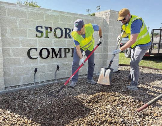 Schulenburg Projects – LCRA employees spread rock at the Sports Complex (left photo) and installed metal trim and weed control fabric at three city sites, including a site on East Avenue (right photo), during LCRA’s Steps Forward Day on April 11.