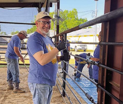 At the Emily Fritsch barn at the Fayette County Fairgrounds in La Grange, LCRA employees painted cattle pens for Steps Forward Day.
