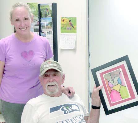 ‘Helping Heroes’ – April Pierson (left) and her father, “Mac” Dennis Schramek, are part of the “Helping Heroes” team. They recently hung artwork on the gallery wall and did a few other jobs. Everyone is invited to come see the art made at Artful Fridays and purchase greeting cards made from the artwork.