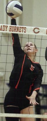 Haylee Vacek knocks down an attack in the second set. Sticker Photo By Darrell Vyvjala