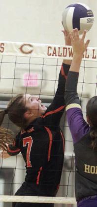 Landry Zapalac tips the ball past a Lady Hornet in the second set. Sticker Photo By Darrell Vyvjala