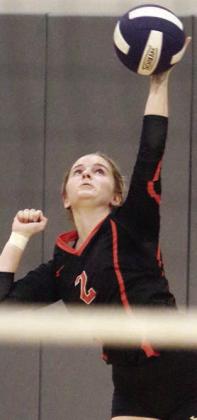 Madison Kunschick serves an ace in the first game. Sticker Photo By Darrell Vyvjala