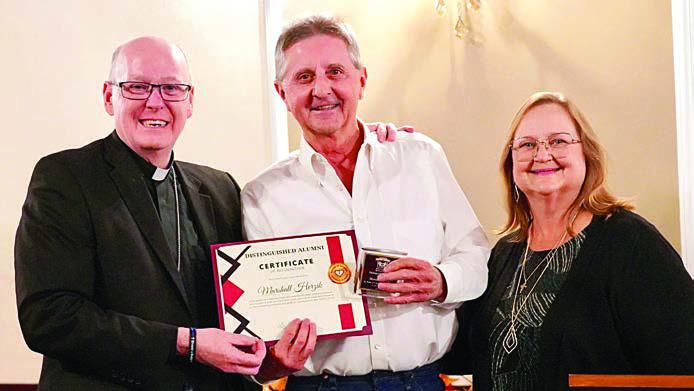 Marshall Herzik (center) was presented the Distinguished Alumni Award at an event in Victoria on Oct. 16 as the recipient from St. Rose of Lima Catholic School. He is shown with Diocese of Victoria Bishop Brendan Cahill (left) and St. Rose principal Rosanne Gallia (right).