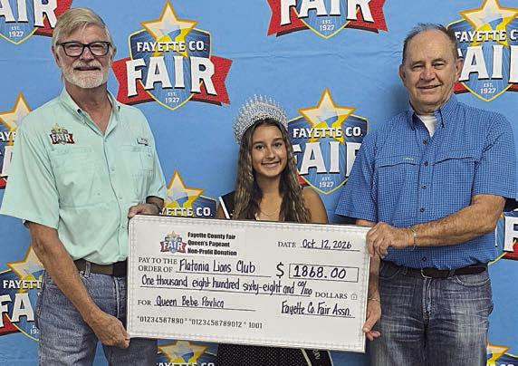 Flatonia Lions Club – Fair president Michael Zuhn (left) presents a donation of $1868 to the Flatonia Lions Club, represented by David Urban (right), with Queen Bebe Pavlica (center).