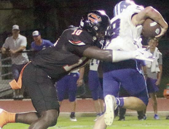 Tavondrick Ellison chases down Trent Sevcik for a loss of 3 in the second quarter. Sticker Photo By Layne Vyvjala