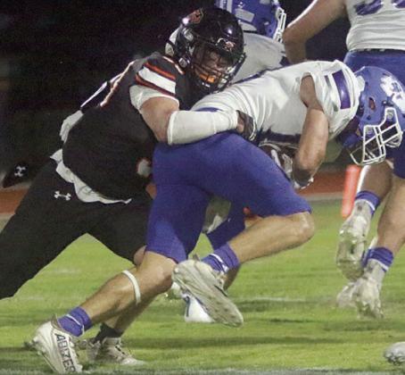 Preston Kahn brings down Clayton Haas for a 1-yard gain in the first quarter. Sticker Photo By Layne Vyvjala