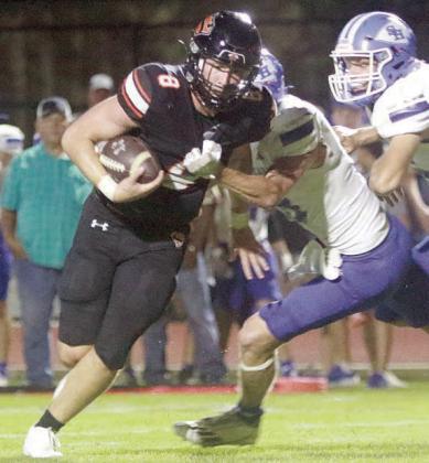 Owen Brenek pulls away from an Indian in the backfield to score the Horns’ first touchdown of 2025. Sticker Photo By Layne Vyvjala