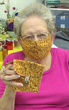 MATCHING MASK &amp;amp; PURSE – Navidad Valley Community Connections member Irene Janda wears a mask and holds the matching purse. The purse is only the size of a folded mask, and attaches to a regular purse, belt or backpack. The matching masks and mini-purses are available by contacting NVCC.