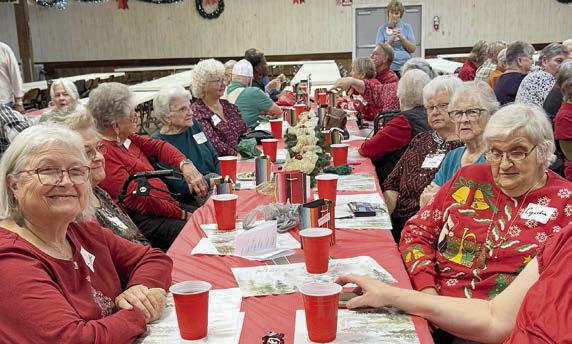 Members anxiously await a del icious meal at the Senior Connections holiday celebration.