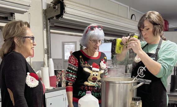 Amanda Kridel (right) uses her new potato masher while Cynthia Trojacek (left) and Stefni Kuntz (center) observe.