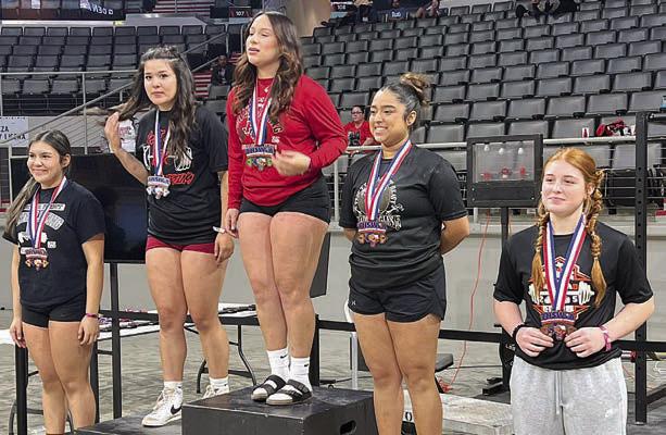 Katry Kobza (right) takes the medal stand at regional after her fifth-place finish.